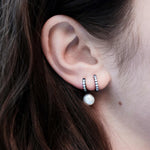 Şener Besim Black Rhodium White Diamond Medium Huggie worn on ear, sterling silver