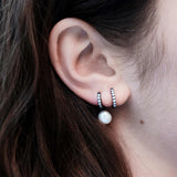 Şener Besim Black Rhodium White Diamond Medium Huggie worn on ear, sterling silver