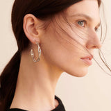 Şener Besim Large Helix Hoops silver worn on ear, sculptural helix design, rhodium plating