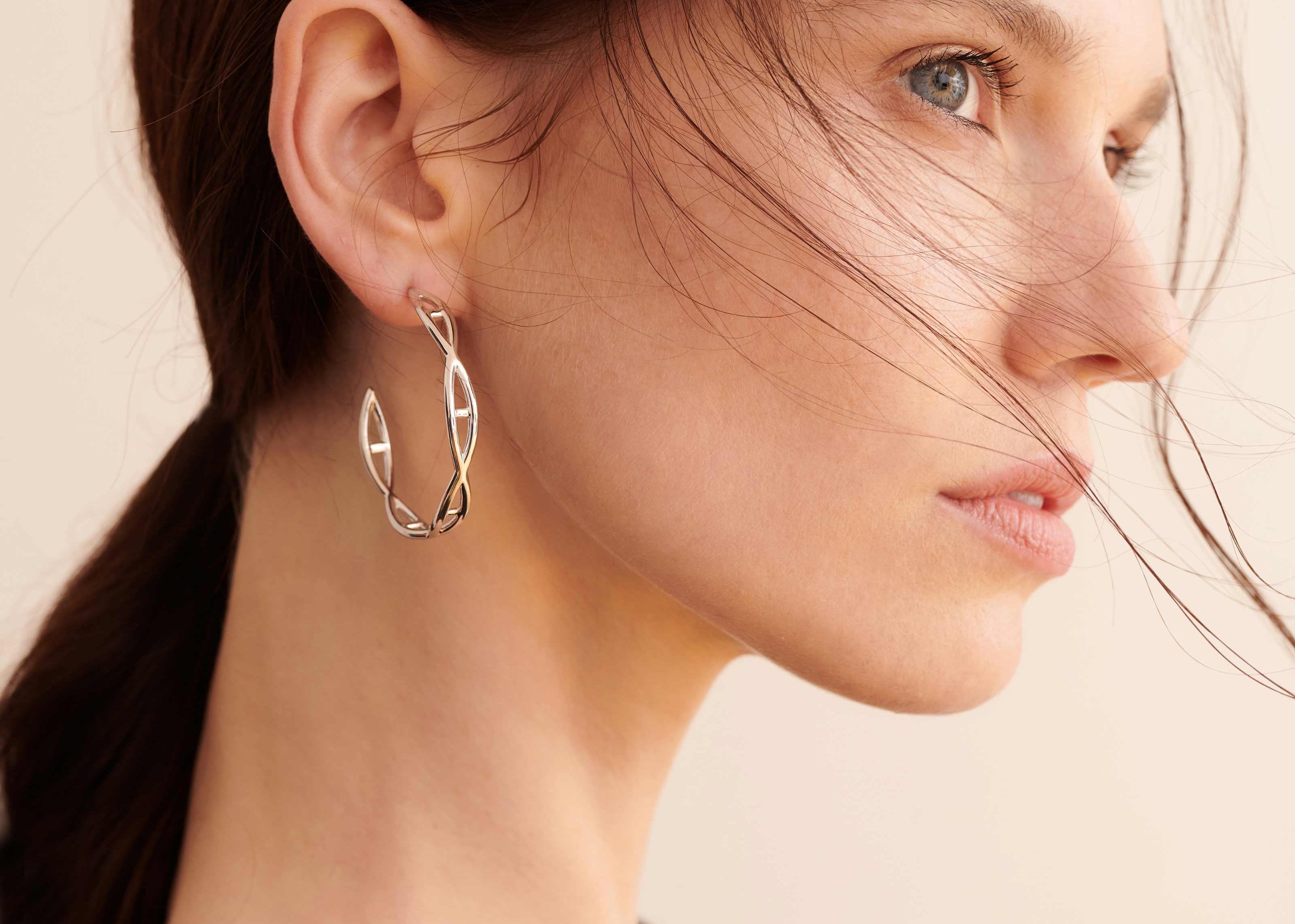 Şener Besim Large Helix Hoops silver worn on ear, sculptural helix design, rhodium plating