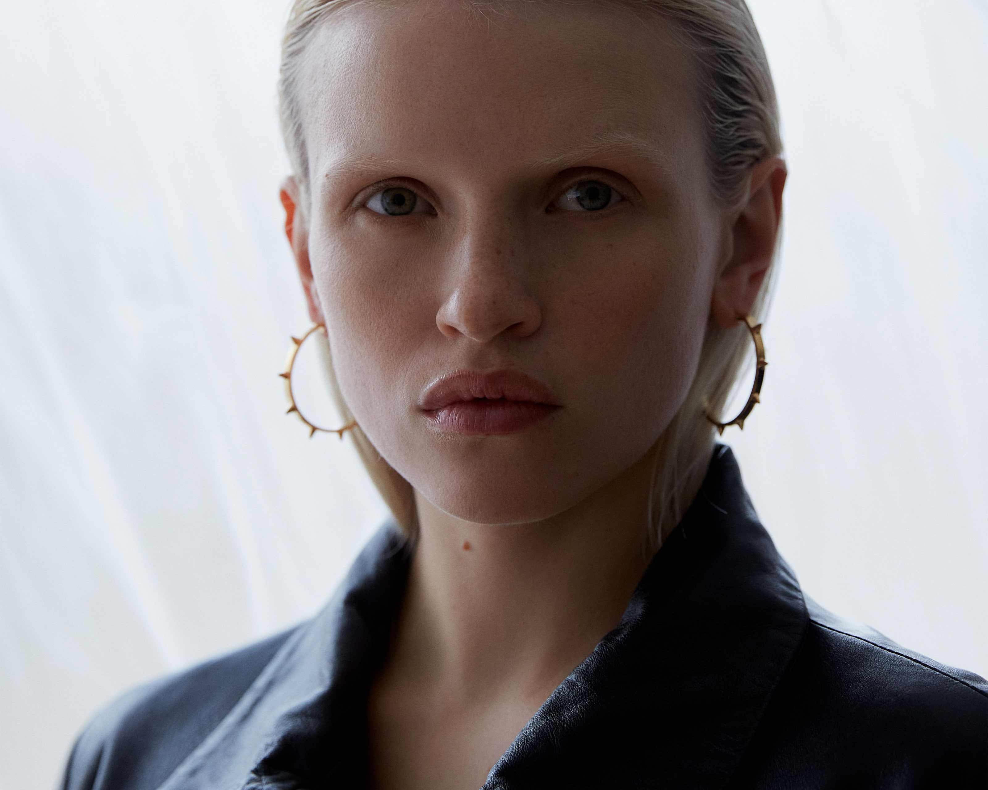 model wearing large spike hoops statement jewellery by sener besim