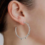 model wearing sener besim large spike earrings 