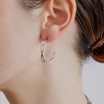 Şener Besim Medium Helix Hoops silver worn on ear, sculptural helix design, rhodium plating
