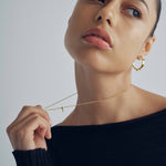 model wearing sener besim mdedium sized statement earrings with spikes