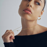 model wearing sener besim mdedium sized statement earrings with spikes