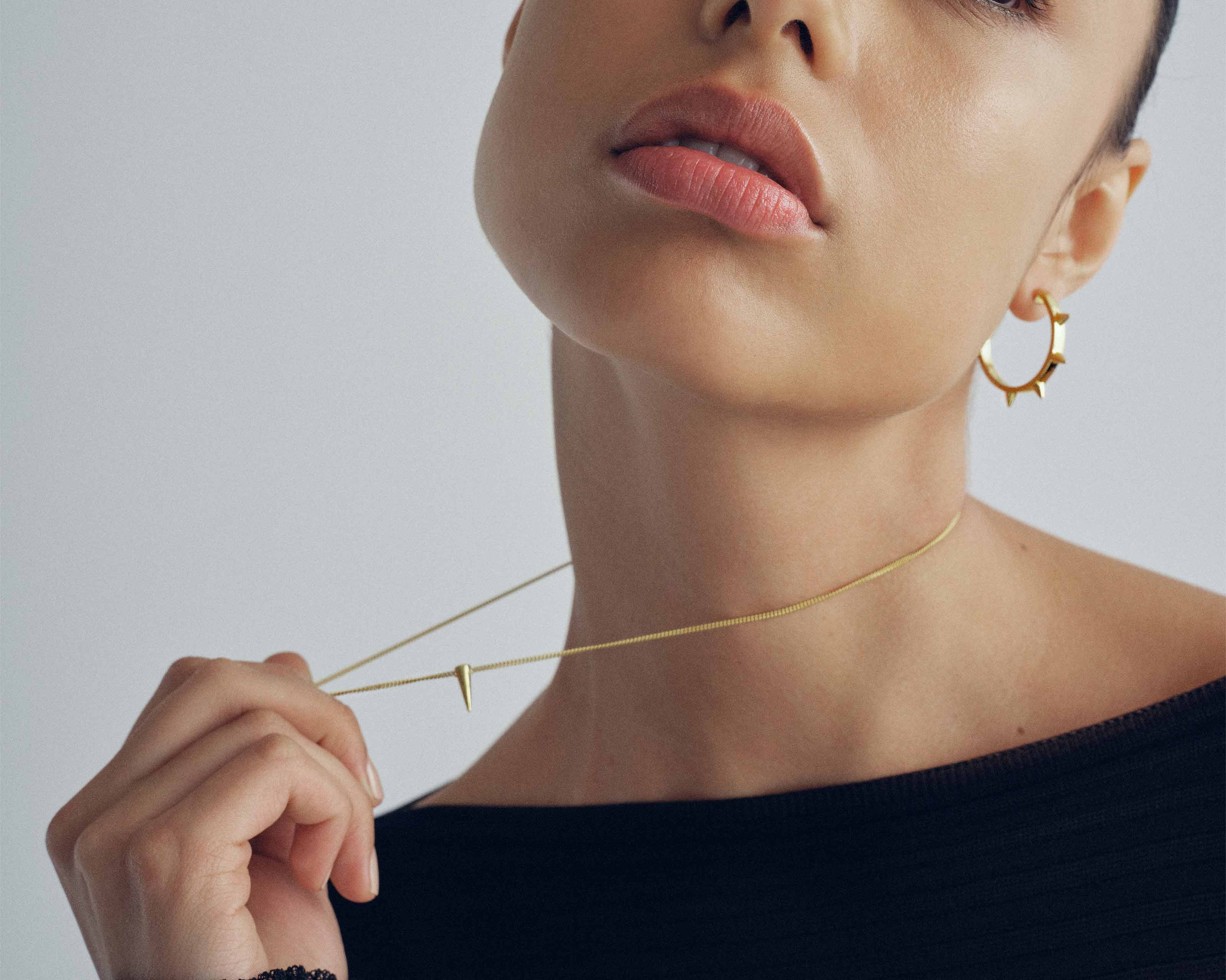model wearing sener besim mdedium sized statement earrings with spikes