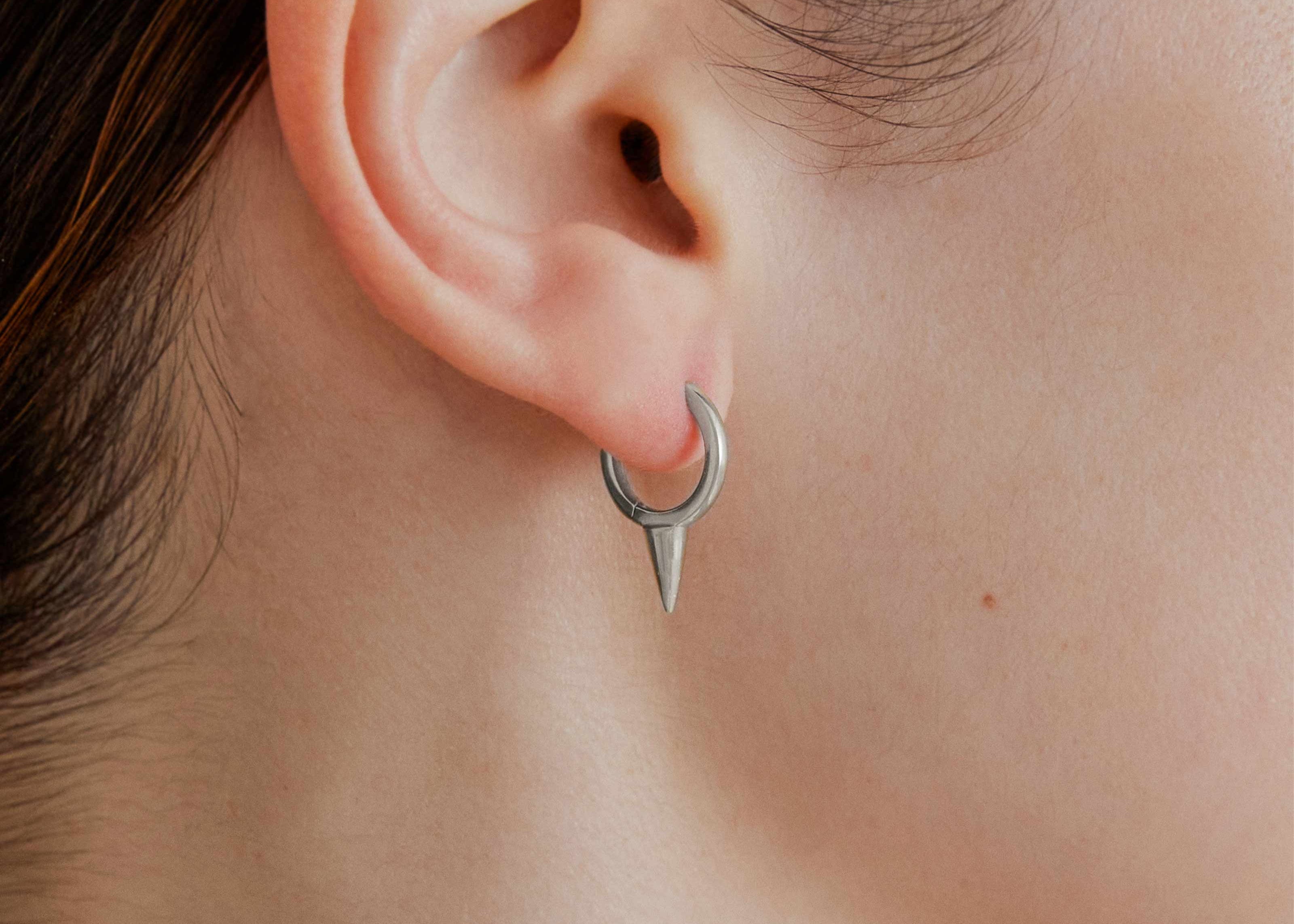 Şener Besim Medium Single Point Huggies in silver rhodium plating, worn on ear