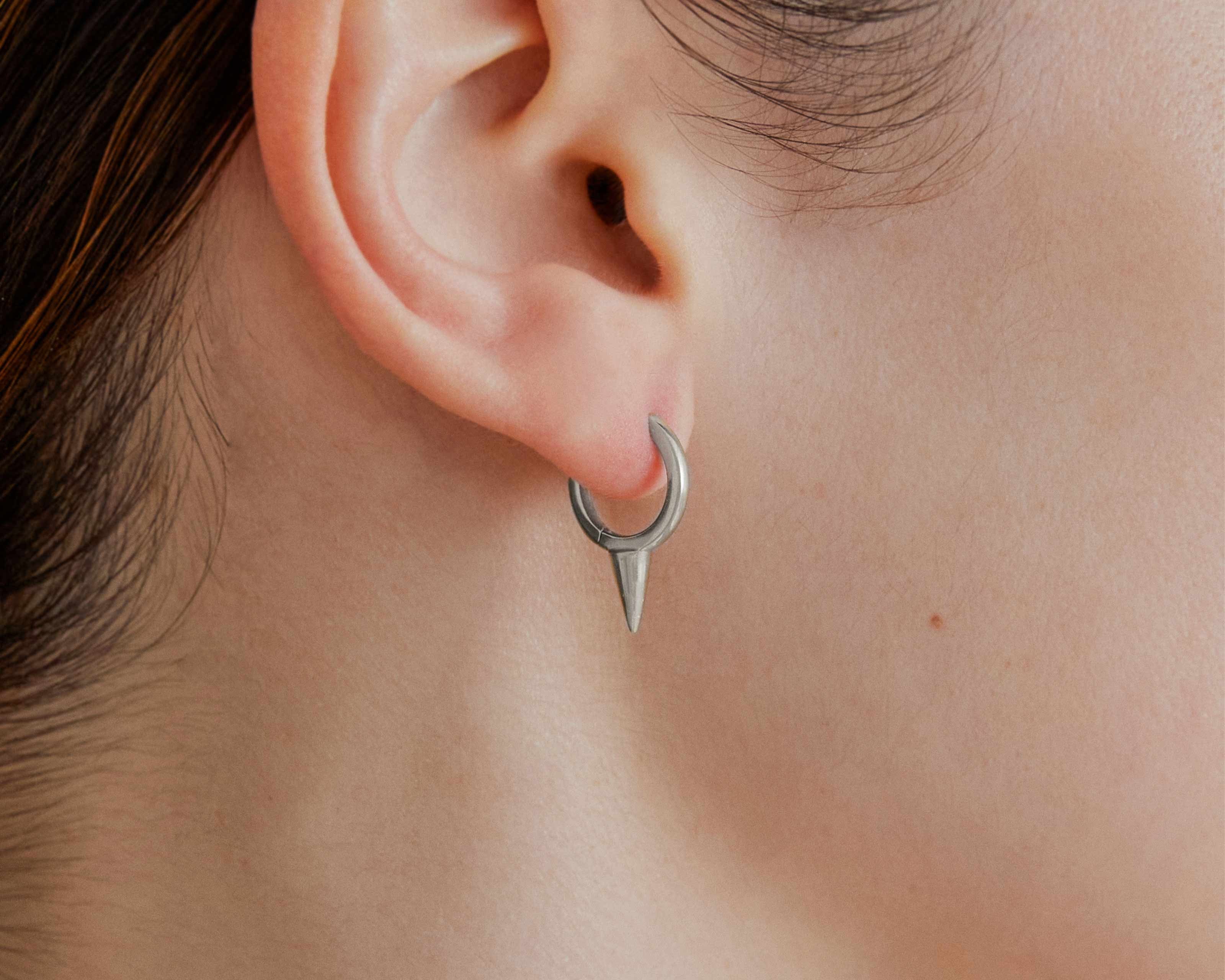 Şener Besim Medium Single Point Huggies in silver rhodium plating, worn on ear