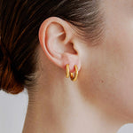 Şener Besim Medium Tube Huggies in 14ct gold plating — worn model