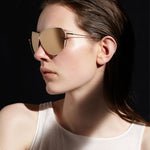 Şener Besim S2 sunglasses in aurous gold, aviation grade titanium frame, worn model