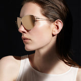 Şener Besim S2 sunglasses in aurous gold, aviation grade titanium frame, worn model