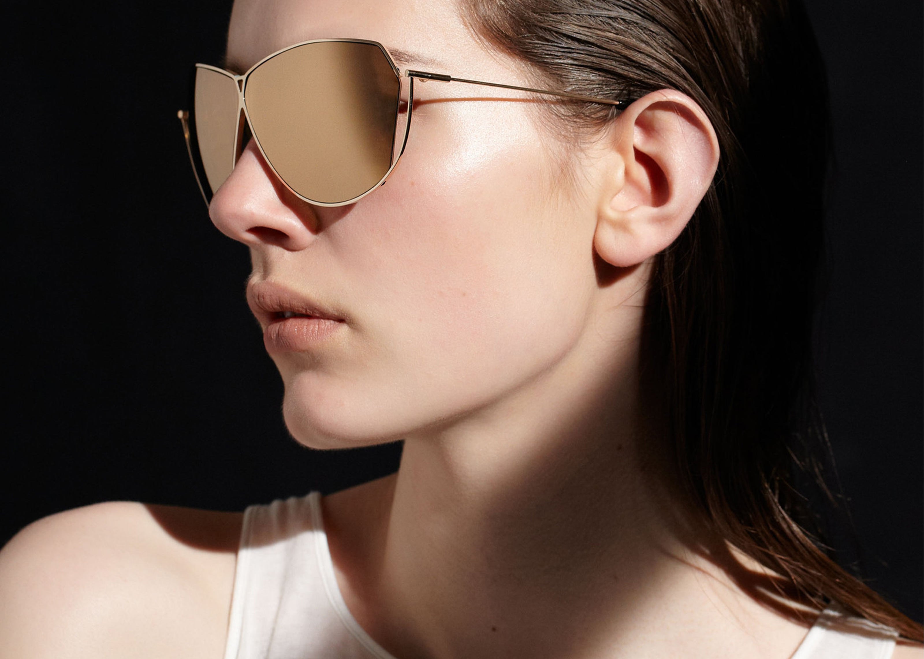 Şener Besim S2 sunglasses in aurous gold, aviation grade titanium frame, worn model