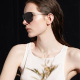 Şener Besim S2 sunglasses in nero graphite, aviation grade titanium frame, lifestyle shot