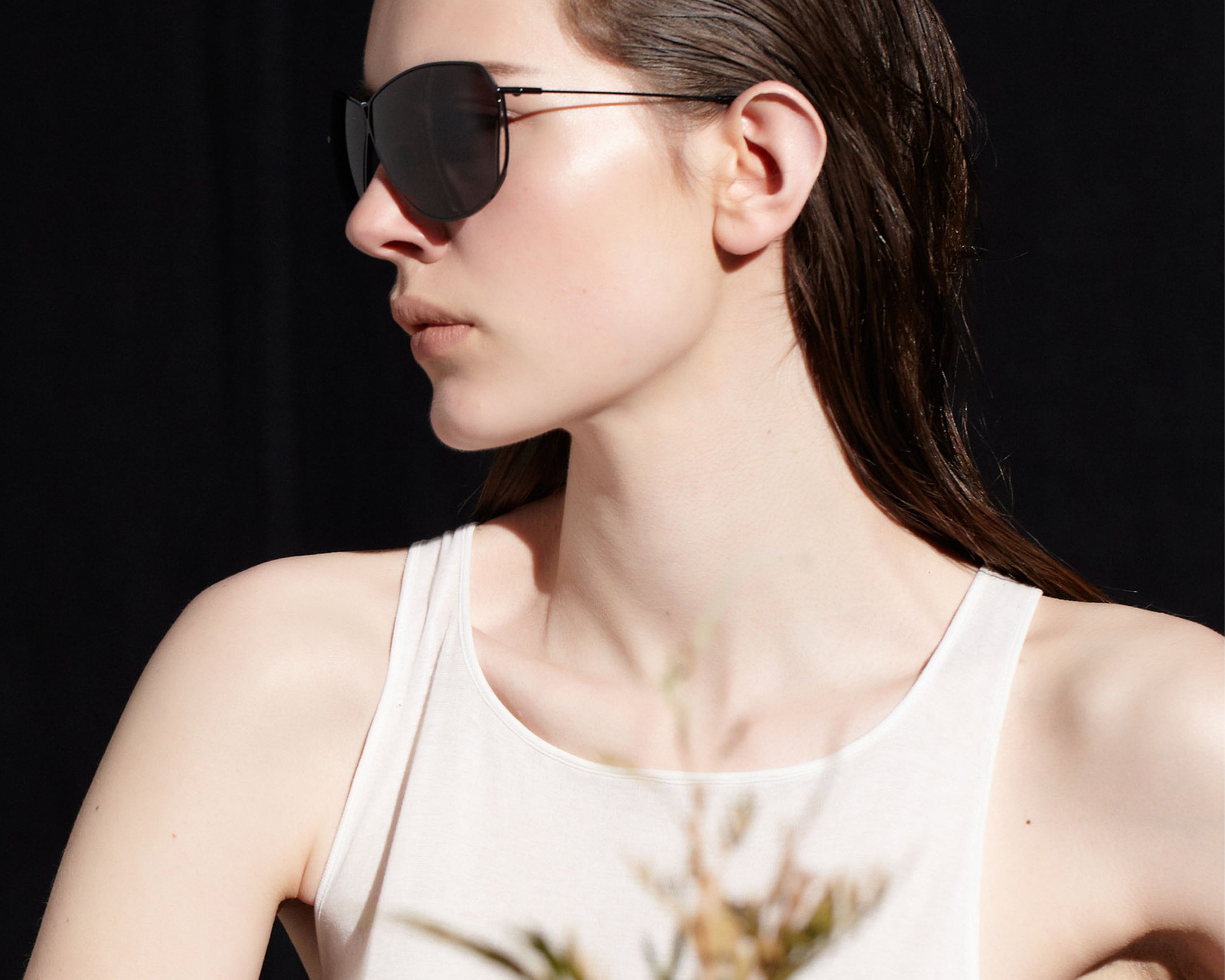 Şener Besim S2 sunglasses in nero graphite, aviation grade titanium frame, lifestyle shot
