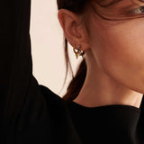 model wearing small sener besim earrings with spikes