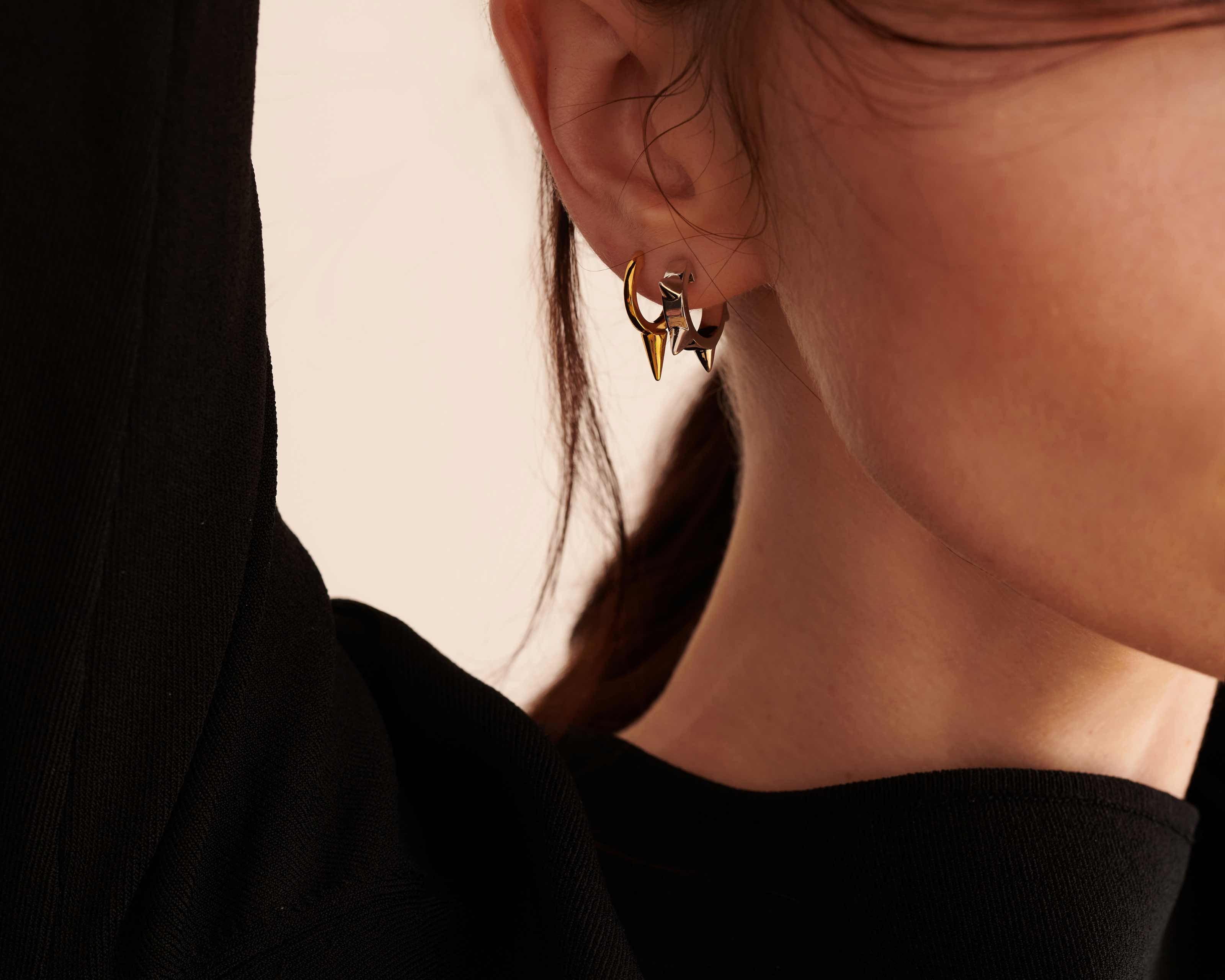 model wearing small sener besim earrings with spikes