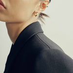 model wearing sener besim spike detailed earrings in gold